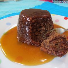 a piece of chocolate cake on a plate with caramel sauce