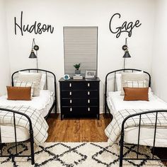 two twin beds in a bedroom with black and white decor