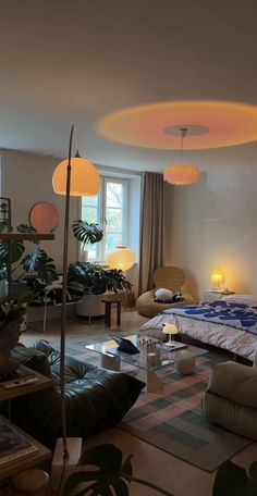 a living room filled with lots of furniture and plants on the floor in front of a window