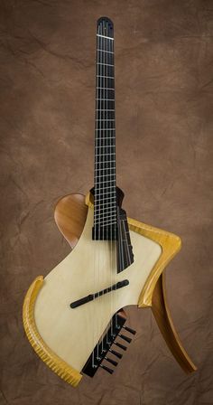 an electric guitar hanging from the side of a wooden stand on a brown wall background