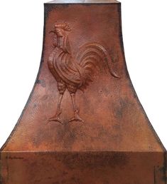 a copper colored oven hood with a rooster on it