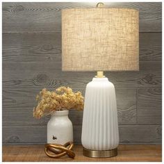 Base Dimensions: 5.5" W x 5.5" D Shade Dimensions: 9.5" H x 12" W x 12" D Full Height: 23.25" Cord Length: 62" Bulb Type: A 100W Power Source: Corded Electric Material: Ceramic, Fabric & Metal Color: White, Gold & Beige Quantity: 1 Enhance your space with neutral decor like this White Ribbed Ceramic Table Lamp. This lamp has a charming appearance with its matte, ribbed base and gold details. A large, beige lamp shade completes the overall look with a natural touch. Place this accent lamp in your living room to complement your traditional or farmhouse style! Soft White Walls, Beige Lamp, Beige Lamps, Minimalist Bedside Table, Touch Lamps, Electric Material, Farmhouse Table Lamps, Frame Light, Ceramic Table Lamp