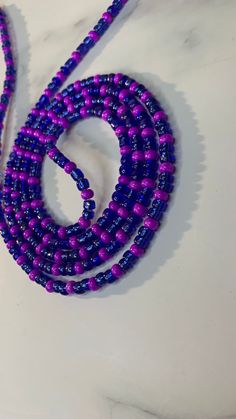 Handcrafted waist beads in our blue and purple. All waist beads are made with glass seed beads. Our tie-on waist beads come with cotton beading string from Ghana, and our removable clasp, options comes with our extra strong elastic threading. All waist beads are made to order.  Our waist beads come in the traditional tie-on method and a clasp method. The tie-on method is for permanent everyday wear. The clasp method is for the unicorns who like to be versatile and take their waist beads off whenever they choose.  MEASURING YOUR WAIST Please measure your waist in the area where you would like your waist beads to fall. Waist beads can be worn at the hipline and the natural waistline.  After measuring your waist please add at least a one to a two-finger gap for a comfortable fit. Blue Round Beads Waist Beads For Gift, Blue Waist Beads Gift, Blue Waist Beads With Spacer Beads As Gift, Blue Colorful Waist Beads As Gift, Blue Beaded Waist Beads As Gift, Handmade Blue Waist Beads As Gift, Purple Beaded Chain Bracelets For Festival, Handmade Blue Waist Beads Gift, Spiritual Purple Spacer Beads