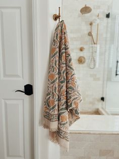 a towel hanging on the wall next to a shower