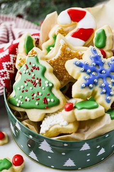 a tin filled with christmas cookies on top of a table