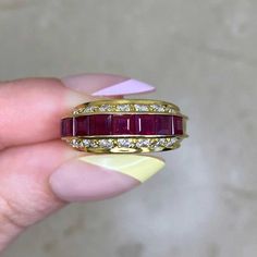 A vintage ruby and diamond ring, featuring a row of eight carré cut rubies. The total ruby weight is approximately 0.80 carats. Eight round brilliant cut diamonds are set in horizontal rows above and below the rubies. The total approximate weight of the diamonds is 0.96 carats. This ring was handcrafted in 18k yellow gold circa the 1970’s.


The width of this ring is approximately 5.26mm.
This ring is currently sized at 5.75 and can be resized at no extra cost.
Ready to Make It Yours? Reserve it Ruby And Diamond Ring, 18k Yellow Gold Ring, Ring Crafts, Yellow Gold Ring, Ruby Ring, Round Brilliant Cut Diamond, Diamond Cut, Yellow Gold Rings, Rings Statement