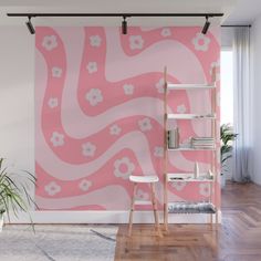 a pink wall mural with white flowers on it