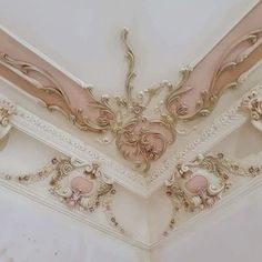 the ceiling is decorated in pink and gold