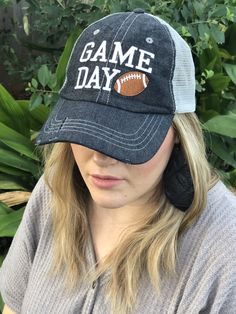 a woman wearing a hat that says game day with an image of a football on it