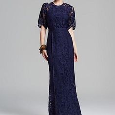 a woman in a long blue lace dress