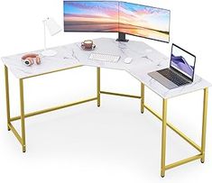 a computer desk with two monitors and a laptop on it's side, in front of a white background