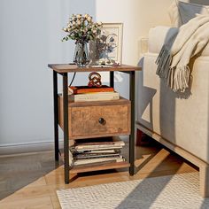 a table with two drawers on top of it next to a couch