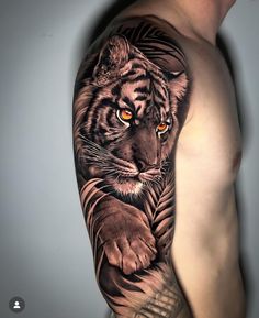 a man's arm with a tiger tattoo on it, and an orange eye