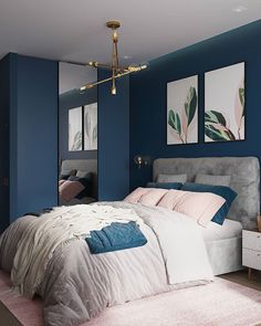 a bedroom with blue walls and white bedding in the center, along with two paintings on the wall