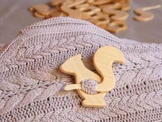 a wooden object sitting on top of a knitted blanket