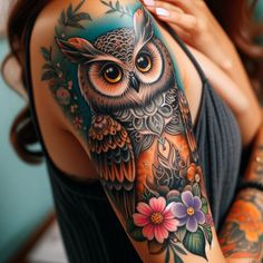 a woman with an owl tattoo on her arm