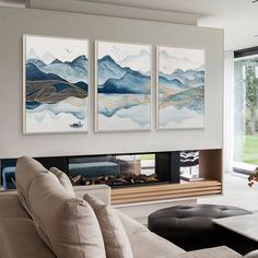 a living room with three paintings on the wall