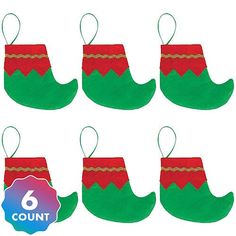 six green and red christmas stockings hanging from strings