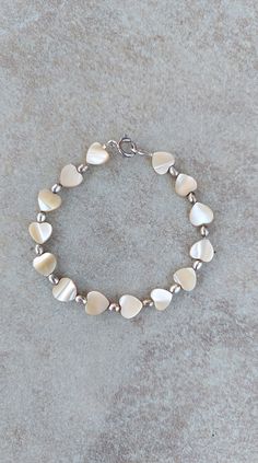 "one of a kind shell bracelet, mother of pearl heart bracelet, cute bracelet for teens Sterling Silver and Shell handmade beaded bracelet, 7.25\" Shell beads are heart shaped 7mm beads. Oval beads and spring ring clasp are sterling silver. Check out my other jewelry at https://loveofjewelryshop.etsy.com" Bracelet Summer, Summer Bracelet, Mother Of Pearl Jewelry, Bracelet Heart, Heart Shaped Jewelry, Seashell Jewelry, Pearl Heart, Oval Beads, Summer Bracelets