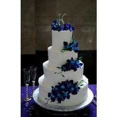 a three tiered cake with blue flowers on it