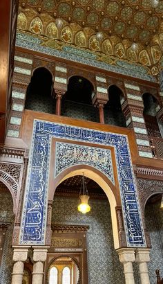 the inside of an ornate building with blue and white tiles