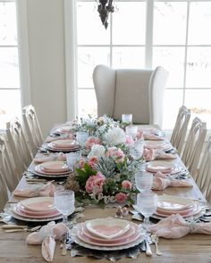 the table is set with pink and white plates