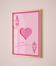 a pink framed print with hearts and playing cards