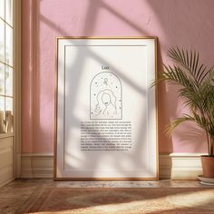 a white framed poster on a pink wall next to a potted plant and window