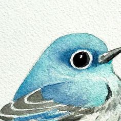 a watercolor painting of a blue bird with black eyes