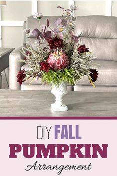 a vase filled with flowers sitting on top of a table in front of a couch