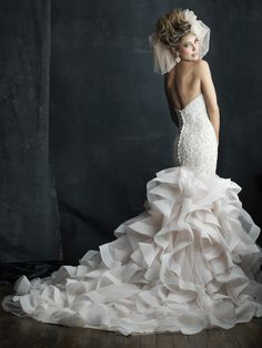 a woman in a wedding dress posing for the camera