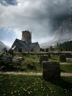 an old cemetery with tombstones in the foreground and a castle in the background