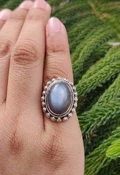 Name of Stone: Moonstone Cut: Smooth Color : Gray Shape: Oval Stone Size: 11 x 15 mm Ring's Weight: 7.20 Gram Country of Origin: Indian Treatment: Natural * Cut & Polished in India * 100% natural & genuine * Measurements & weight are close approximations * We take order work as well. Feel free to contact me for purchasing goods in bulk. * We are manufacturers & Wholesaler of Precious, Semi-precious Loose gemstones, Gemstones Beads, Loose Cabochon, Faceted Gemstone Beads, Chips, Un-Cut Beads etc. Cats Eye Ring, Mystic Quartz, Bella Swan, Cabochon Ring, Eye Ring, Unisex Ring, Inspired Jewelry, Oval Stone, Twilight Saga