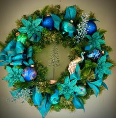 a christmas wreath with blue and green decorations