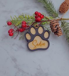 a wooden ornament with a dog's paw and name