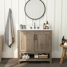 a bathroom with a sink, mirror and towel rack on the wall next to it