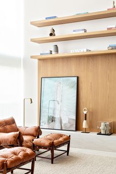 a living room filled with furniture and a flat screen tv mounted on a wall above it