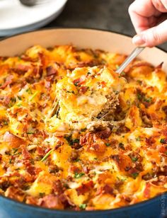 a close up of a casserole in a pan with a spoon