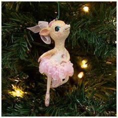 a pink ornament hanging from a christmas tree