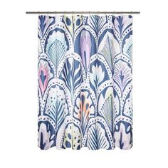 a shower curtain with blue and pink designs on the outside, hanging from a metal rod