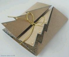 a pair of scissors is tied to some brown paper with gold foil on it's side