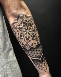 a man's arm with an intricate tattoo design on the left side of his arm