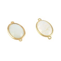 two white and gold tone earrings on a white background, one with a round shape