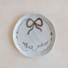 a decorative plate with a bow on it