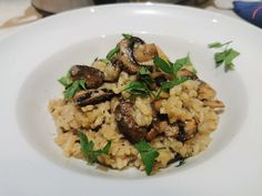 a white plate topped with rice and mushrooms