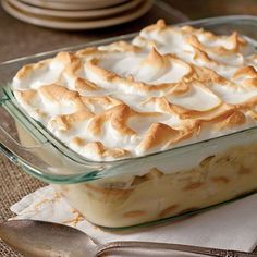 a casserole dish with meringue and cream in it on a table