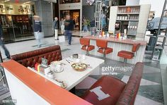 the inside of a restaurant with people walking by