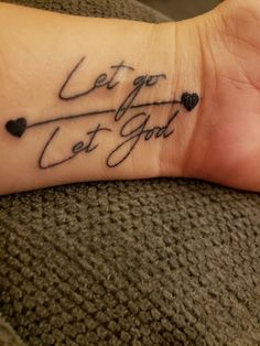 a person's wrist tattoo with the words let go, let god written on it