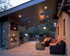 an outdoor living area with fireplace and patio furniture