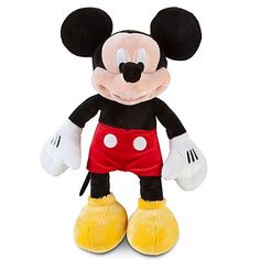 the mickey mouse stuffed animal is wearing red shorts